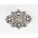 An Edwardian white metal diamond encrusted brooch, set with various sized old mine cut diamonds, the