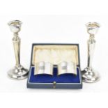A pair of Elizabeth II silver candlesticks by Cohen & Charles, Birmingham 1965, with tapered stems
