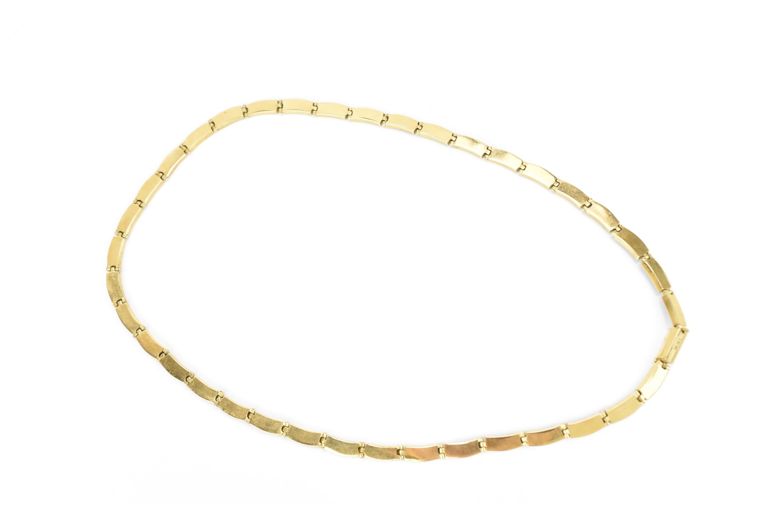 A yellow metal and lapis lazuli necklace, with curved rectangular links each inset with lazuli - Image 4 of 5