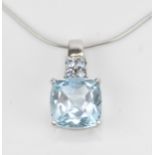 A 9ct white gold, diamond and aquamarine set pendant on chain, the pendant with central cushion