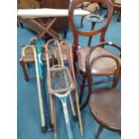 A vintage child's ironing board, 2 cane topped stools, walking canes, a Dunlop tennis racket and