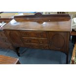 An early 20th century mahogany sideboard having a raised back, three drawers and two cupboard