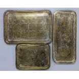 Three Middle Eastern brass trays to include one depicting scenes of warriors Location:
