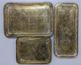 Three Middle Eastern brass trays to include one depicting scenes of warriors Location: