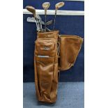 A collection of vintage Technique golf clubs contained in a Dominion leather golf bag Location: