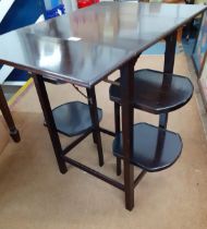 An early 20th century mahogany tea table/cake stand with drop leaves and four flaps along with