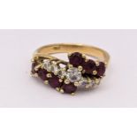 An 18ct gold ring having seven diamonds flanked by seven rubies, 4.8g Location: RING