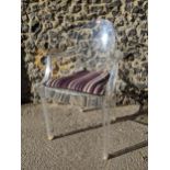 A Louis Ghost Kartell transport polycarbonate armchair designed by Philippe Starck, with