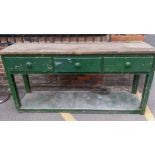 A vintage green painted and pine dresser, three short drawers, the square legs united by an under-