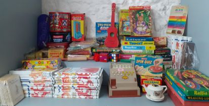 A quantity of vintage puzzles, games and toys to include Waddingtons jigsaw puzzles, a child's