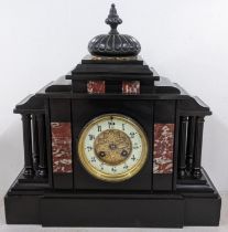 A late Victorian black slate mantle clock of architectural form and striking on a gong Location: