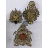 An Oriental gilt metal incense burner cast as the head of Mahakala, together with a Buddha head