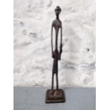 An African bronze elongated figure of a man with a club in his hand Location: