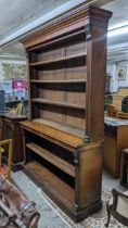 A Victorian walnut bookcase having a stepped cornice open shelves and a plinth base 147h x 181.5w