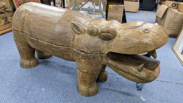 A large moulded sculpture model of a hippo, 43cm h x 98.5cm w Location: