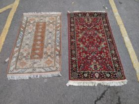 A Turkish milash rug with an abstract design with central orange oblong with nine repeating gulls on