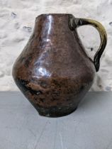 An 18th century Western Asian copper and brass jug Location: