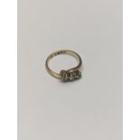 An 18ct gold twist ring, inset with three diamonds, size N½,2.9 Location: RING