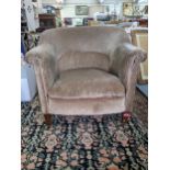 An early 20th century upholstered tub chair on mahogany legs Location: