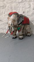 A model of an elephant decorated in mother of pearl on resin Location: