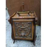 A late 19th century carved oak coal scuttle with carved ornament to the front, metal liner and