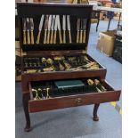 A late 20th century mahogany cutlery table containing mixed Kings pattern gilded cutlery Location: