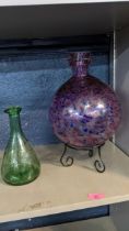 A Murano style art glass vase on a wrought metal base, together with a glass mallet vase Location: