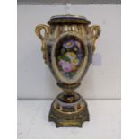 A 19th century porcelain and gilt metal vase and cover decorated with panels of flowers and