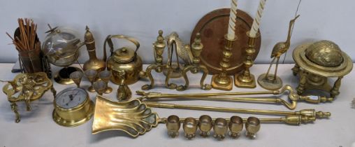 A mixed lot of brassware to include fireside irons, barometer, fire dogs, trench art and other items