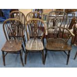A late 19th/early 20th century elm and ash Windsor spindle back armchair and a set of four dining
