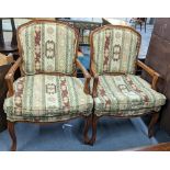 A pair of French style walnut armchairs standing on cabriole legs Location: