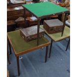 Three early 20th century folding card tables, together with two brown leather cases Location: