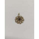 A 9ct gold pendant A/F inset with central garnet and nine pearls in a floral design 4.5g Location: