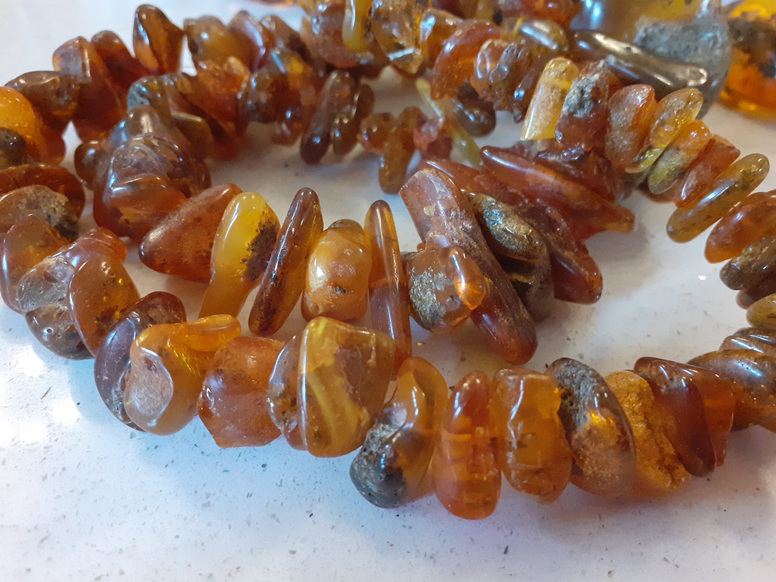 A vintage amber necklace having 15 beads of various sizes and shapes together with 2 vintage rough- - Image 7 of 9