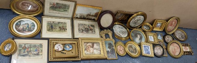 A selection of 19th century and later pictures and frames to include a pair of oval gilt framed