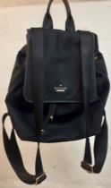 Kate Spade-A black nylon waterproof backpack with drawstring closure having a fold over flap to