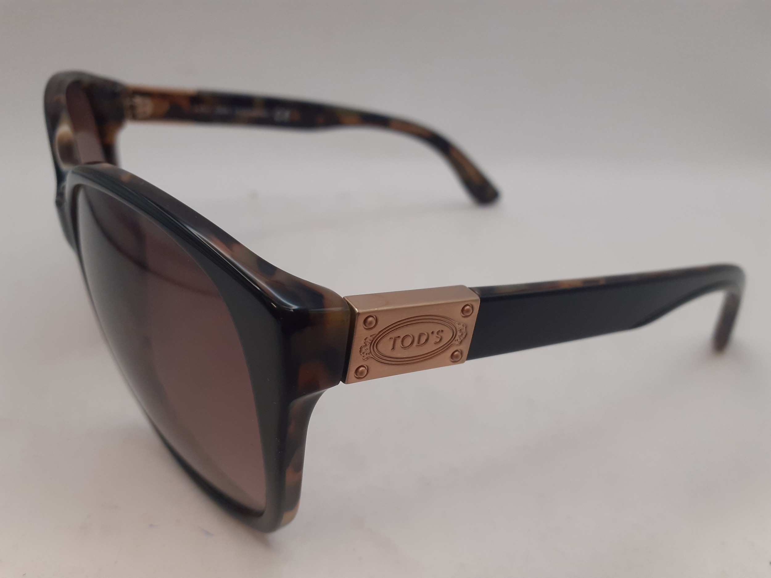 Tods- A pair of brown tortoiseshell effect sunglasses with brown lenses, gold tone branded - Image 2 of 4