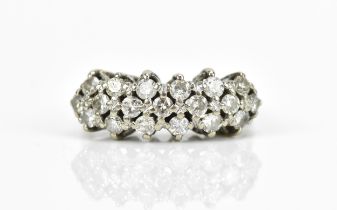 A white metal and diamond three row dress ring, with nineteen pave set brilliant cut diamonds,