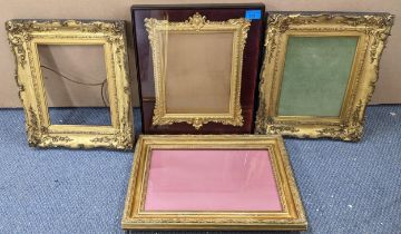 Four gilt picture frames to include a 19th century ornate carved frame decorated with floral