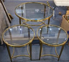 A contemporary brass and glass topped coffee table together with two matching side tables Location: