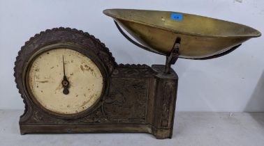 An early 20th century kitchen scales with a panted dial and embossed with a ship and a brass pan