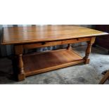 A modern oak two tier coffee table having two drawers and on turned legs, 47cm h x 120cm w Location: