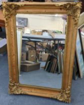A pine framed wall hanging mirror with gilt highlights and moulded border 94cm x 67cm Location: