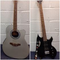 A G2 black electric 4 string guitar with alien shoulder strap together with a Coban 6 string