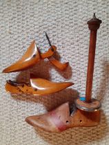 A pair of vintage wooden shoe stays together with a single American boot stay on pole with makers