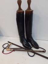 A pair of black leather riding boots measuring 10" from toe to heel together with a pair of
