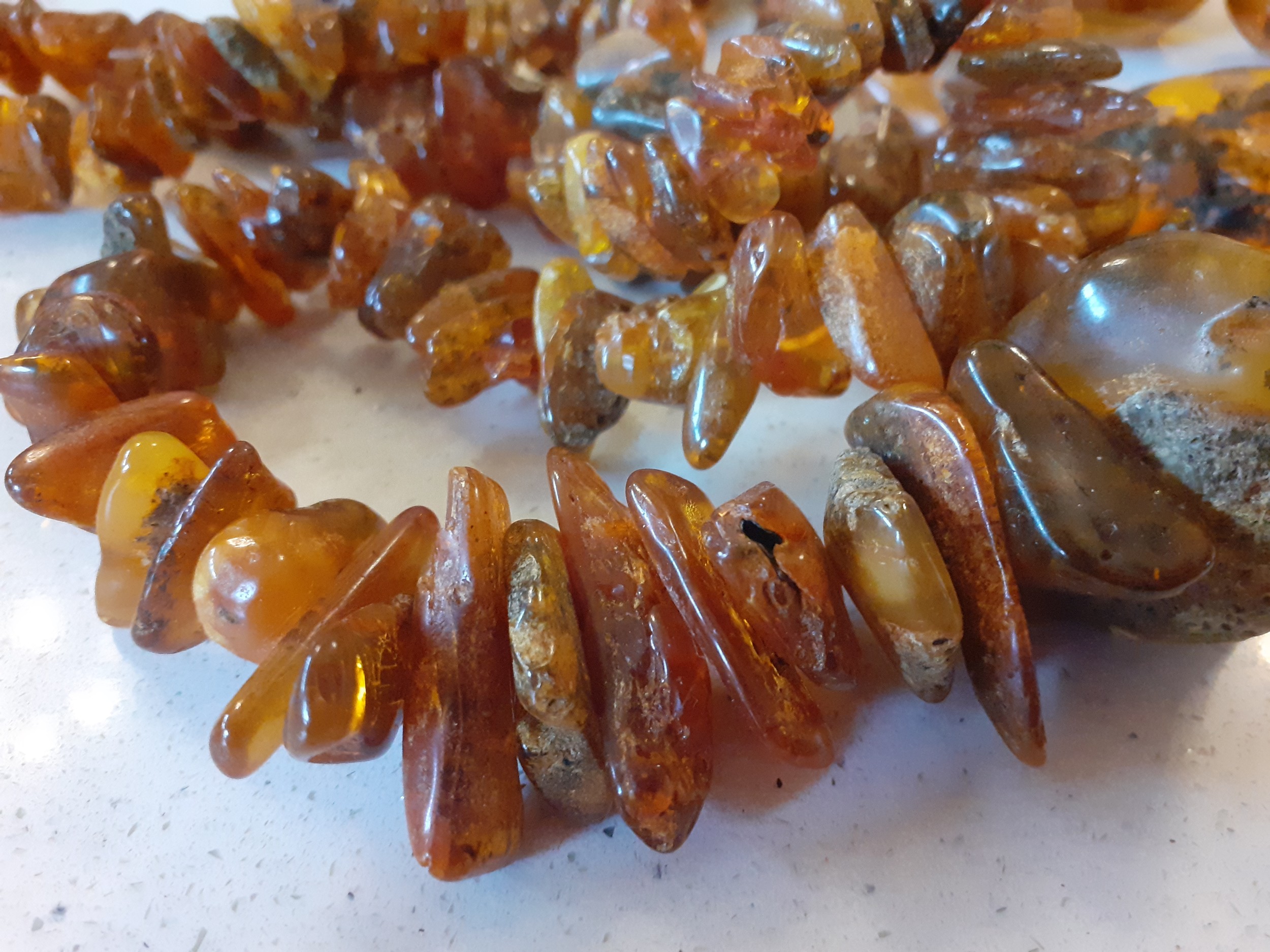 A vintage amber necklace having 15 beads of various sizes and shapes together with 2 vintage rough- - Image 3 of 9