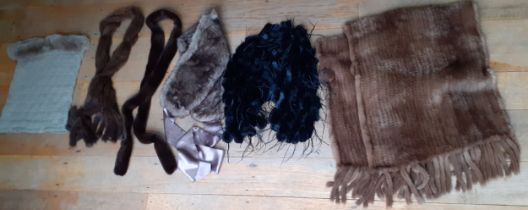 A group of modern fur and faux fur accessories to include a mid brown rabbit fur wrap with pom pom