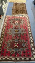 Two rugs to include a Turkish red ground and cream border repeated motifs 185cm x 105cm together