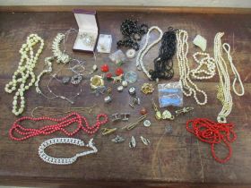 A quantity of costume jewellery to include a Morton gold and silver tone brooch with two stones